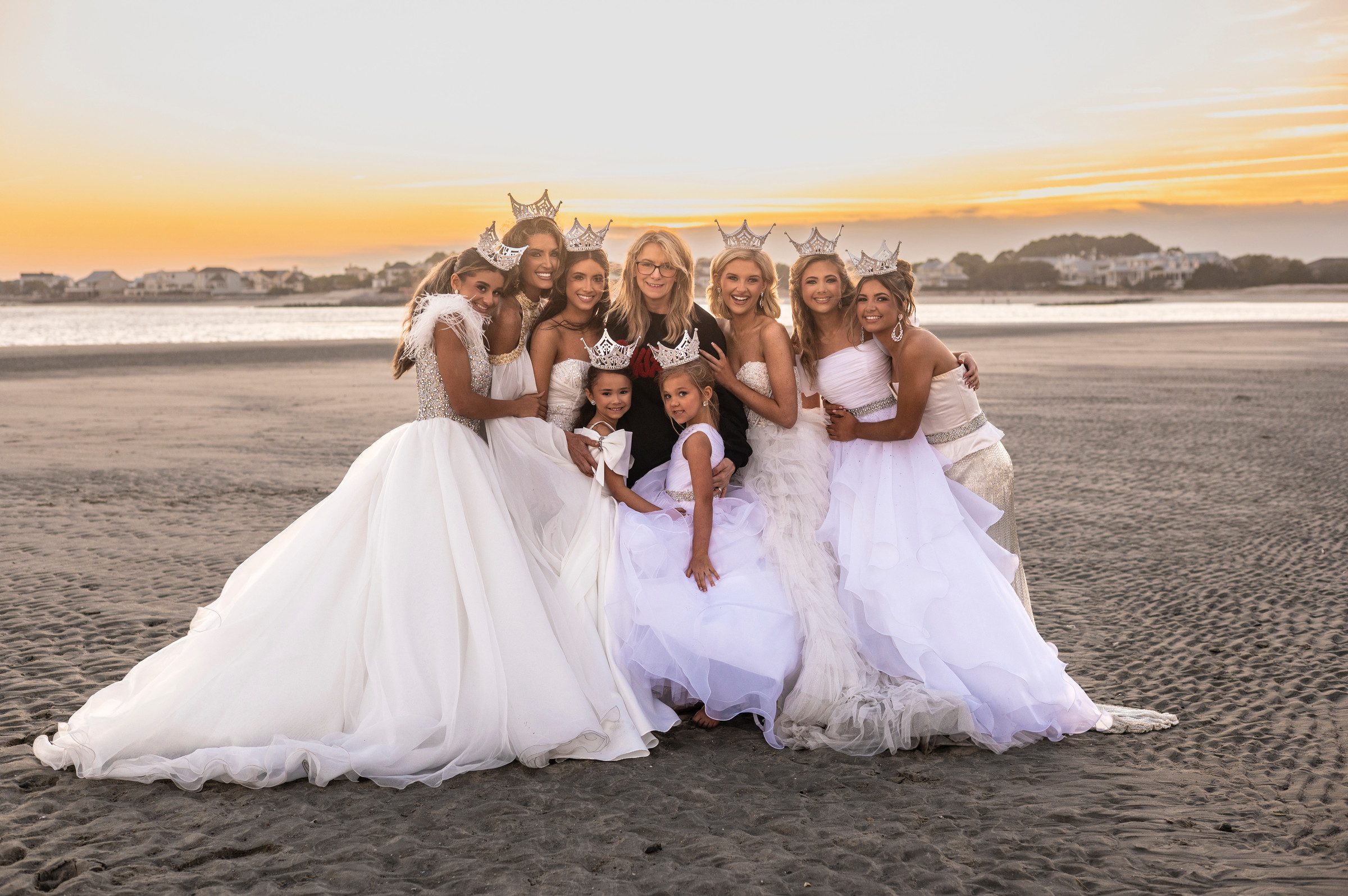 Royalty USA national queens on the beach at sunset in their crowns and gowns